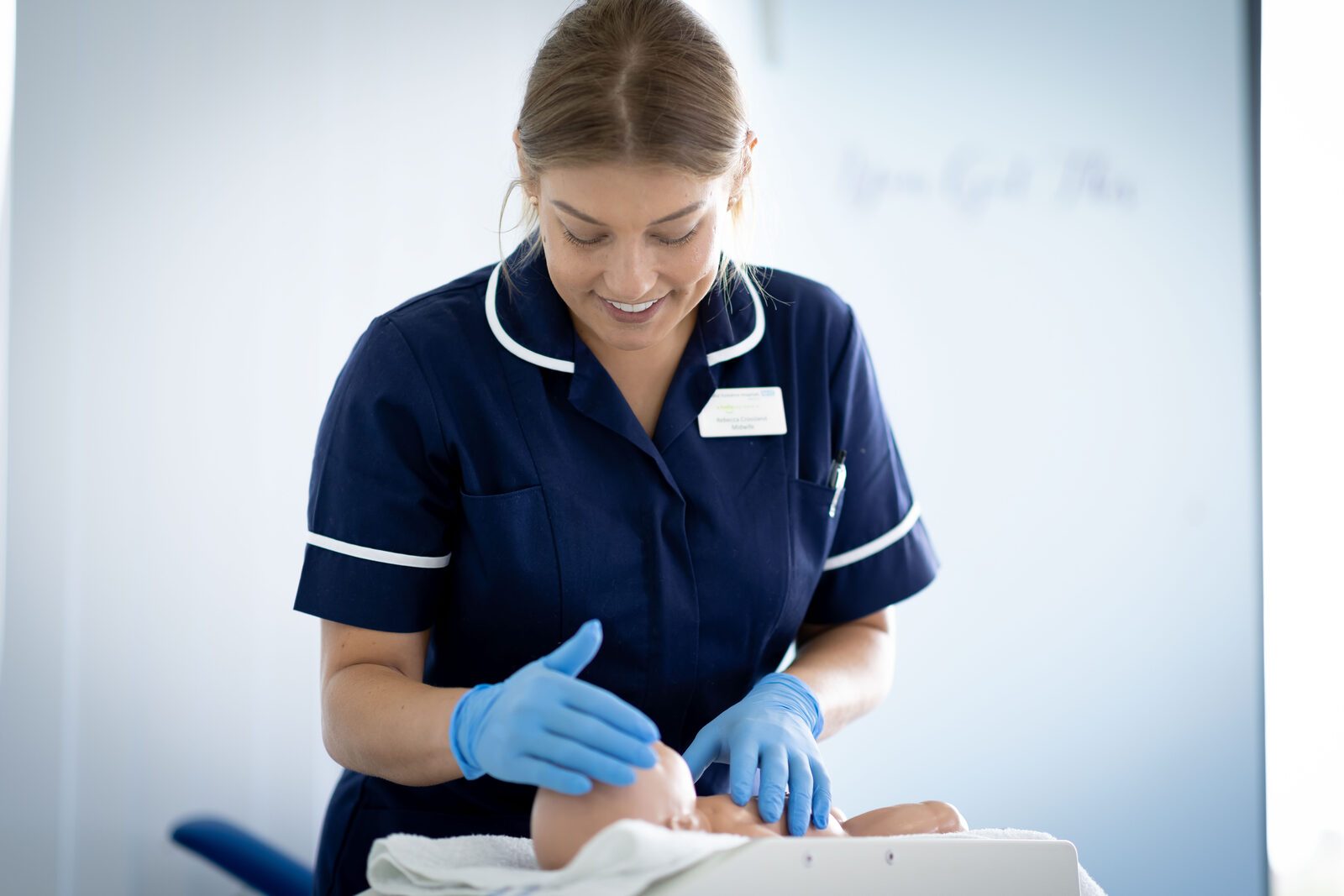 A midwife examining a newborn baby