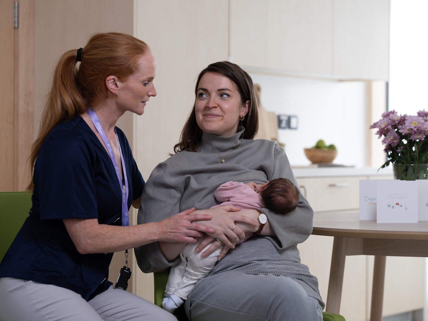 A midwife with a mother and her newborn baby
